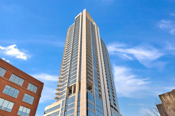 Front view of a high-rise building against a blue sky.
