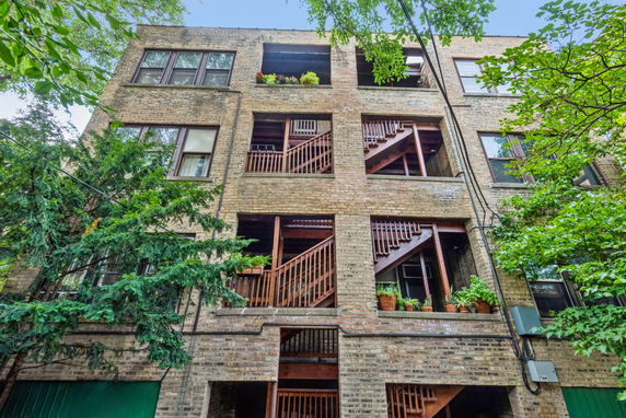 Front view of a multi-story brick building with open staircases.