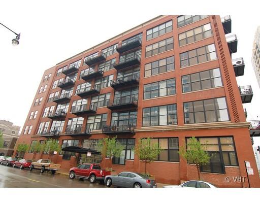 Front view of a multi-story brick building with balconies.