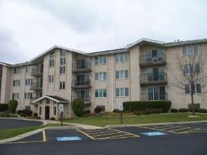 Front view of a multi-story apartment building with balconies.