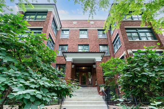 Front view of a brick building with multiple windows and a central entrance.
