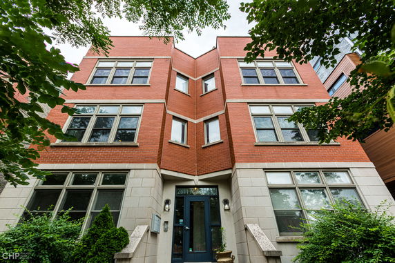 Front view of a red-brick multi-story residential building.