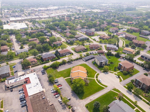 Panoramic aerial view of a residential neighborhood with multiple houses and roads.