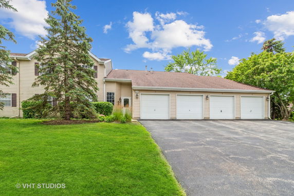 Front view of a house with four garage doors