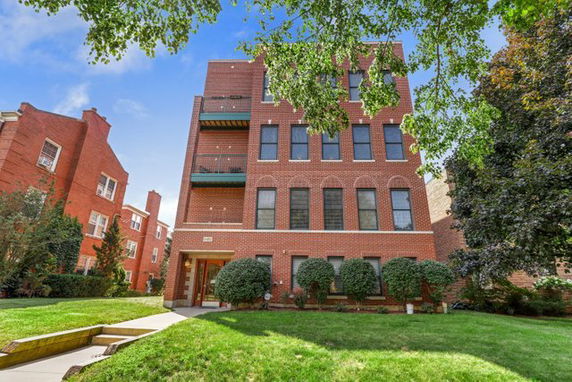 Front view of a multi-story brick apartment building.