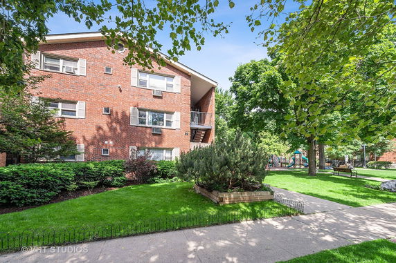 Front view of a multi-story brick apartment building.