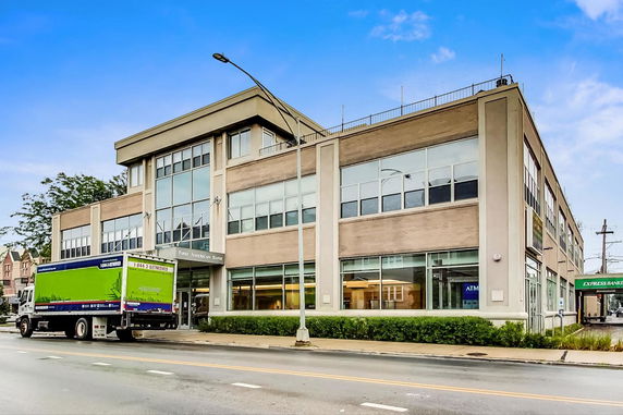 Front view of a two-story commercial building with large windows.