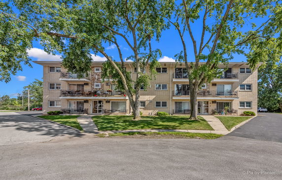 Front view of a three-story apartment building with balconies.