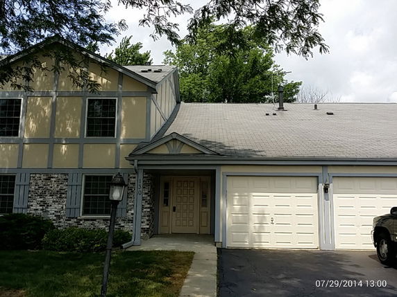 Front view of a two-story house with a double garage.