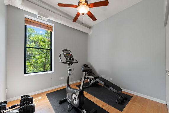 Home gym area with exercise equipment and a window view.