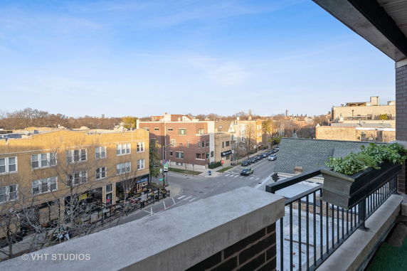 Panoramic view of buildings and street from a higher vantage point.