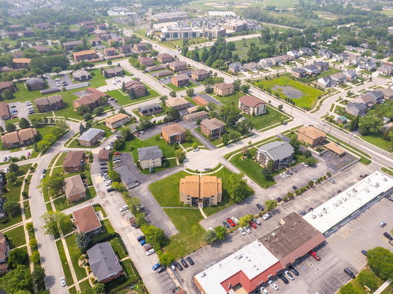 Aerial view of a suburban neighborhood with multiple residential buildings and streets.