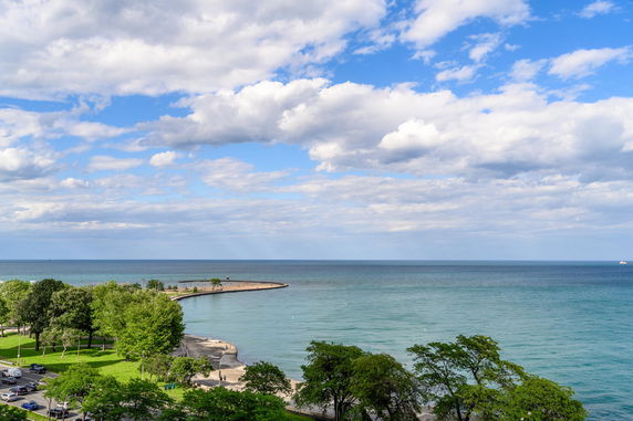 Panoramic view of a coastline with blue water and sky.