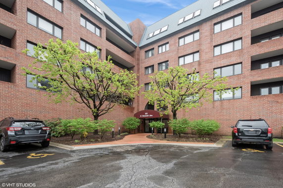 Front view of a multi-story brick building with a central entrance.