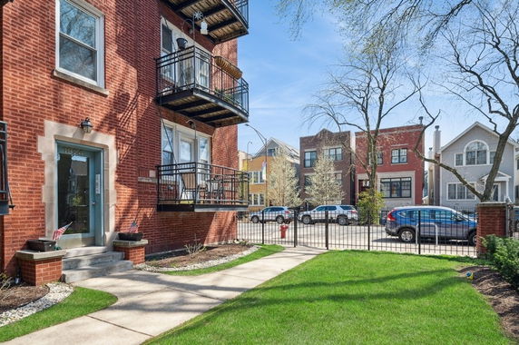 Front view of a multi-story brick building with balconies.