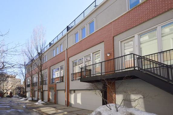 Front view of a multi-story building with brick and stucco facade.