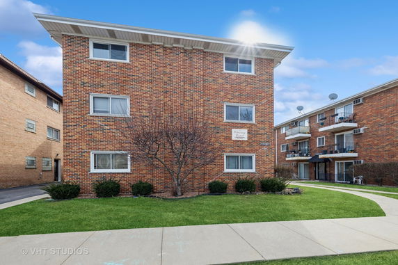 Front view of a three-story brick apartment building.