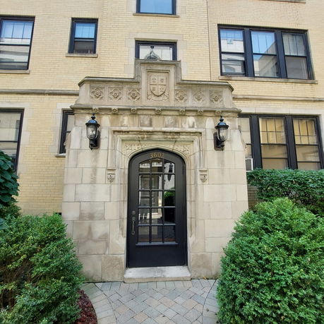Front view of a residential building with decorative stone entrance