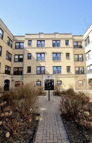 Front view of a multi-story building with brick facade.