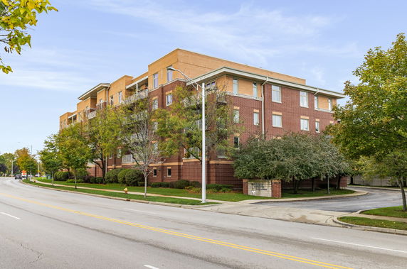 Front view of a multi-story brick apartment building.