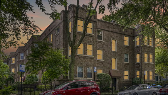 Front view of a three-story brick apartment building.