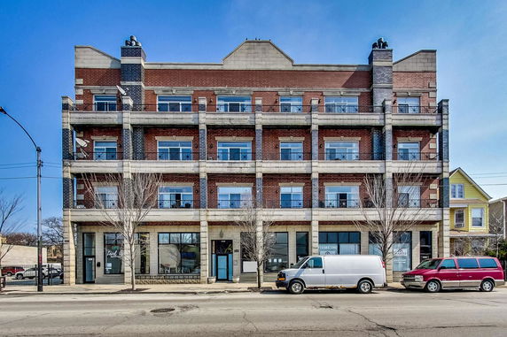 Front view of a multi-story building with brick and stone facade.