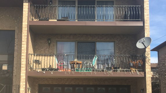 Front view of a multi-story building with balconies.