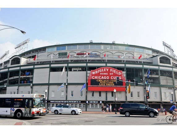 Front view of a large stadium with a distinctive red marquee.