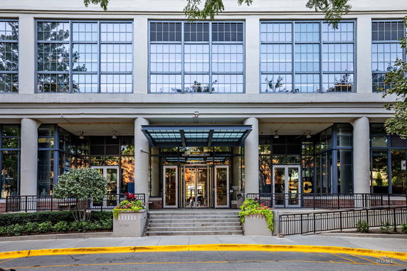 Front view of a building with large glass windows and a modern entrance.