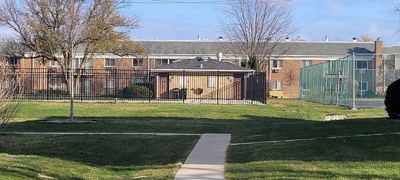 Front view of a two-story brick apartment building.
