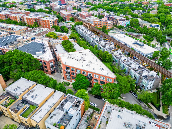 Aerial view of urban residential area with multiple residential buildings and greenery.