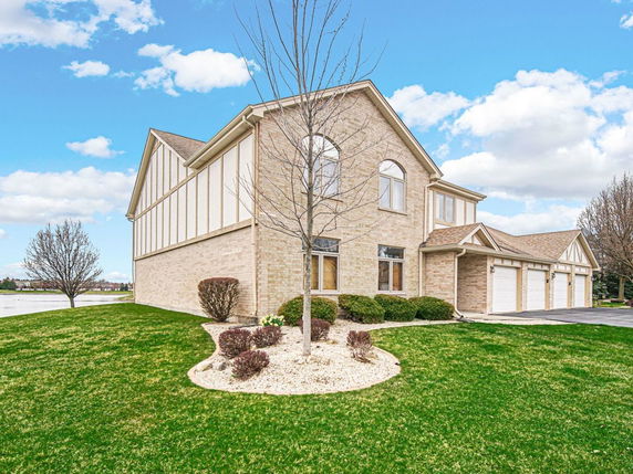 Front view of a two-story house with a three-car garage.