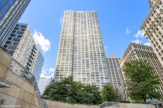 Front view of a tall skyscraper in a city setting.