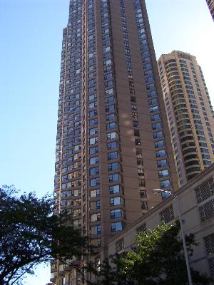 Front view of a tall residential skyscraper with numerous windows.