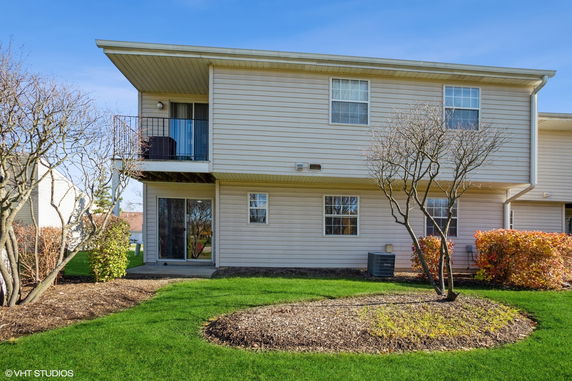 Front view of a two-story house with a small balcony.