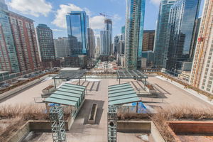 Rooftop area with pergolas and city skyscrapers in the background.