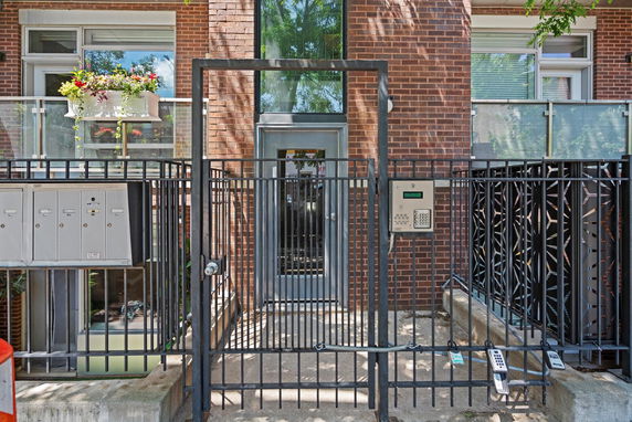 Front view of a building entrance with a secure gate.