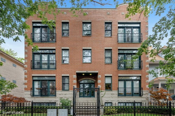 Front view of a multi-story brick apartment building.