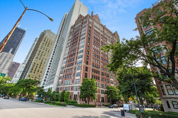 Front view of a high-rise building with a brick facade.