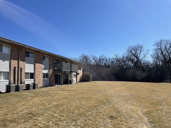 Front view of a two-story residential building with multiple balconies.
