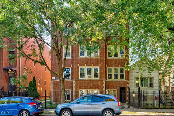 Front view of a three-story brick apartment building.