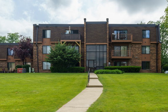 Front view of a three-story apartment building with balconies.