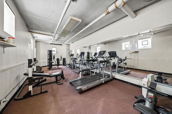 Indoor gym area with various exercise equipment.