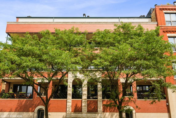 Front view of a multi-story building with brick facade.