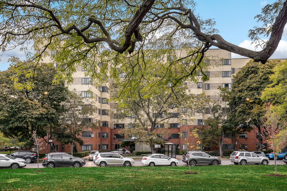 Front view of a multistory residential building with a brick facade.