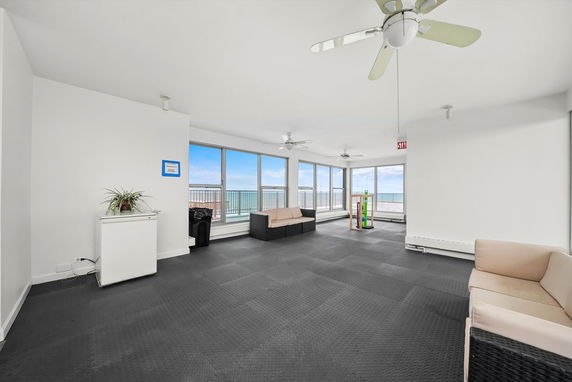 Room with large windows and seating area.
