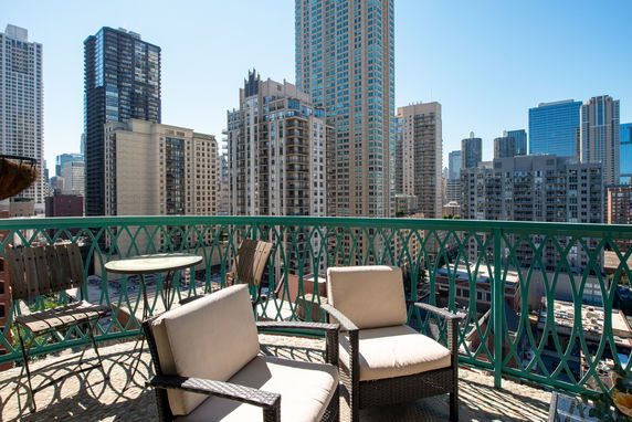 Panoramic view from a balcony overlooking a cityscape with tall buildings.