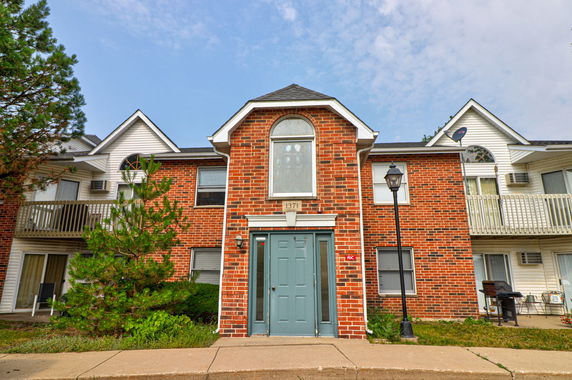 Front view of a two-story brick building with balconies.