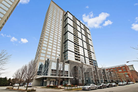 Front view of a modern high-rise building with reflective windows.