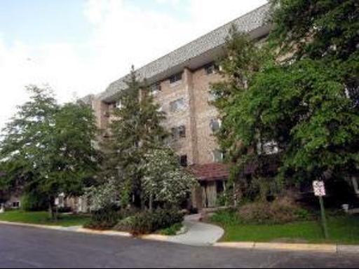 Front view of a multi-story building with a brick facade.